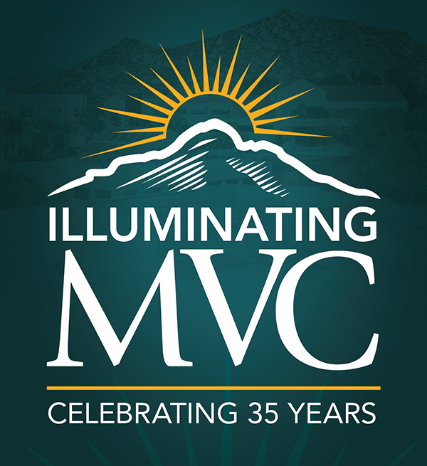 Logo in white and yellow of a mountain with light on the summit, above the words Illuminating MVC