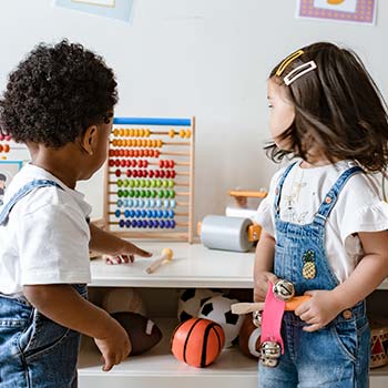 Two children play with an abacus