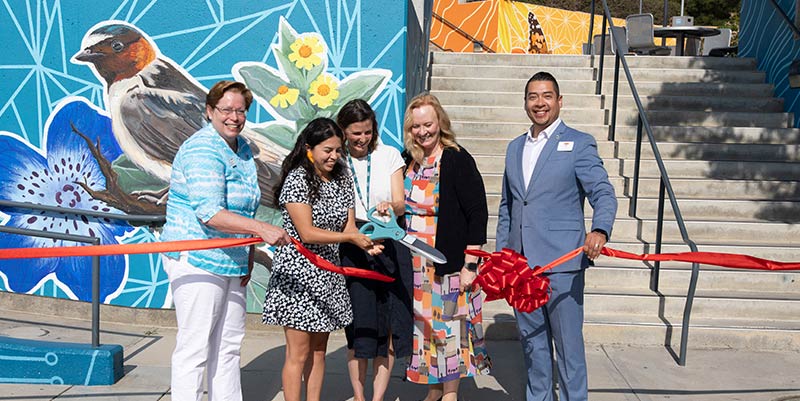 Artist Rosy Cortez stands with representatives of the District, College, and City of Moreno Valley at the mural's ribbon cutting