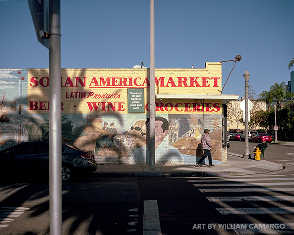 Thumbnail of William Camargo's color photograph, After Stephen Shore But In Penguin City and Paisa, showing colorful corner street architecture