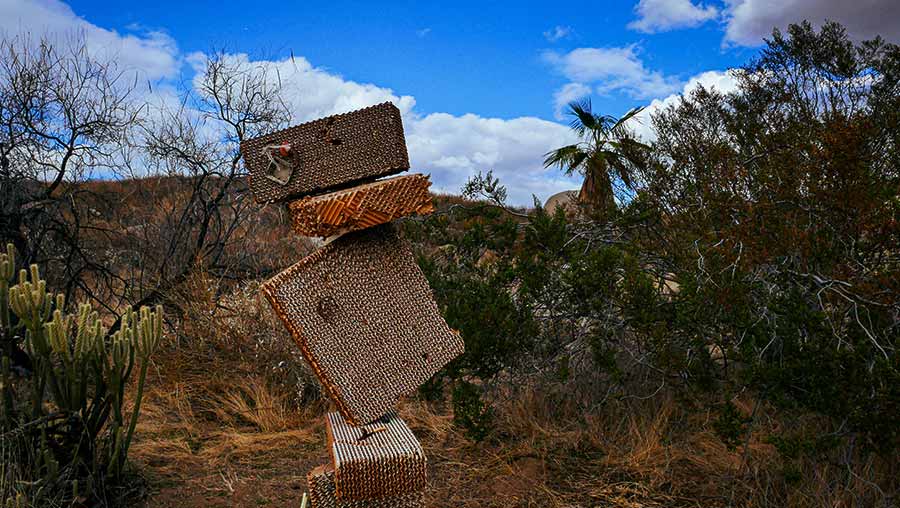 Making Refuge installation showing a stacked pile of corrugated cardboard in the shape of a person without arms or legs