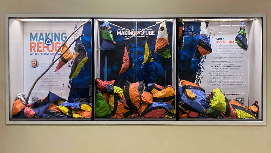 Making Refuge installation in Humanities with colorful inflated paper mache bags hanging off branches