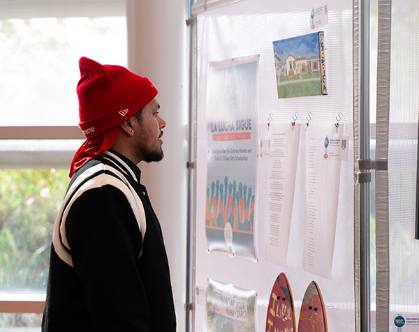 A student looks at student artwork from past arts receptions