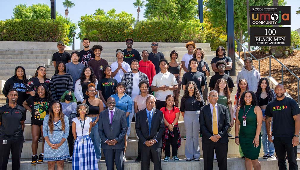 A group of Umoja students stand with 100 BMIE representatives