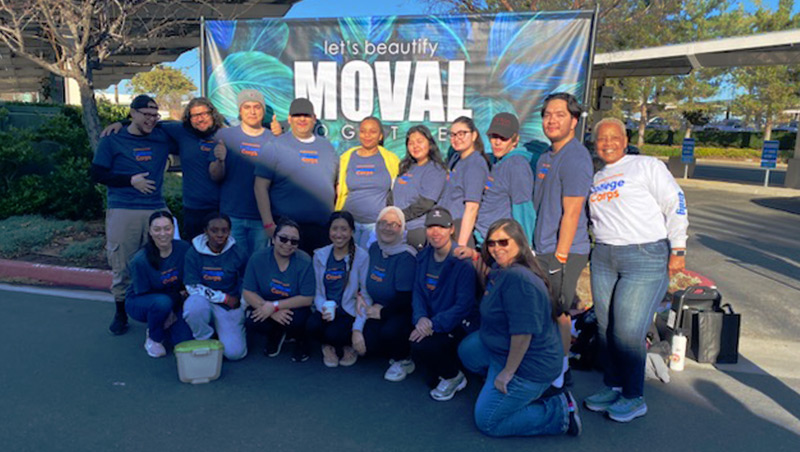 College Corps students and coordinator Frankie Moore stand in front of a Beautify MoVal banner.