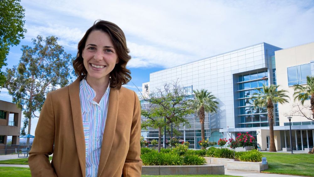 A portrait of Lauren Johnson standing in front of the MVC Student Academic Services Buiding