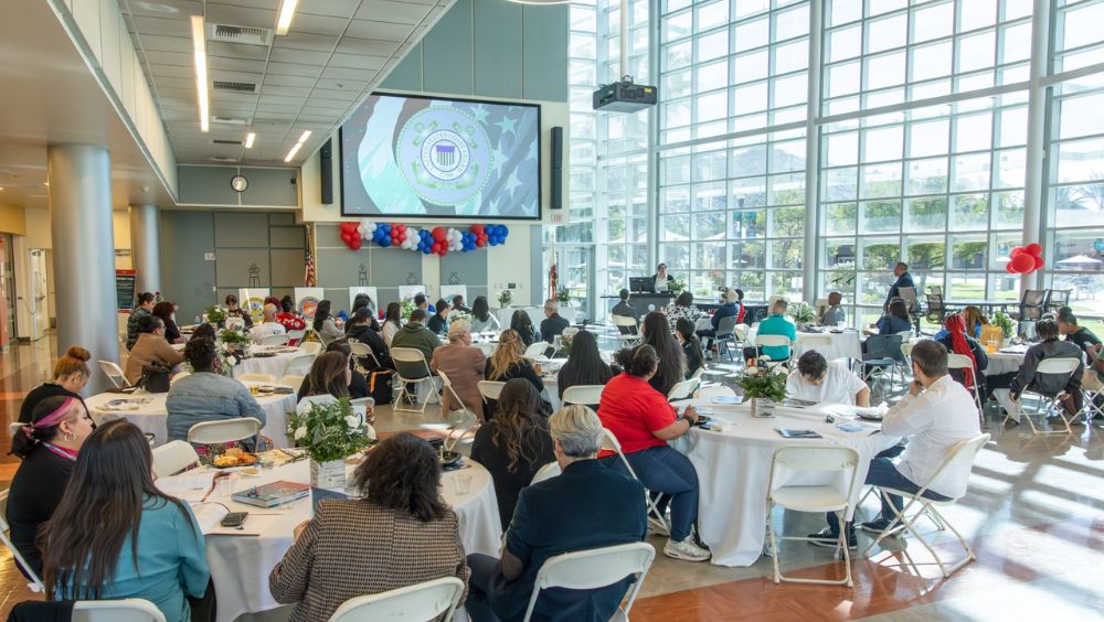 A wide shot of the room capturing guests attending the event.