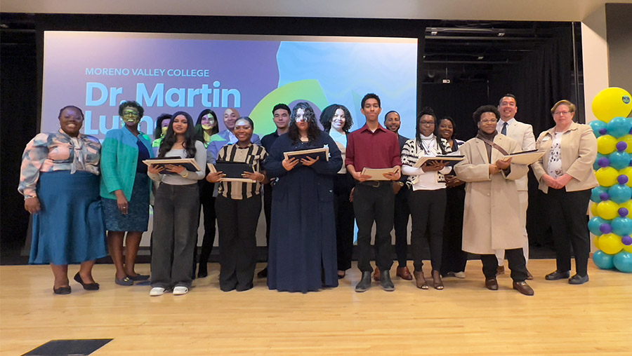 MLK scholarship recipients, judges and community leaders stand together for a group photo