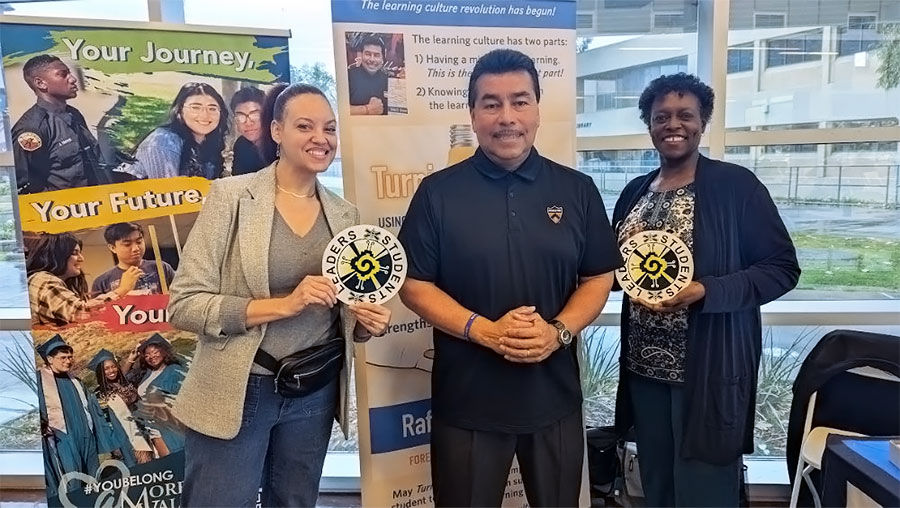 Alvarez stands surrounded by Erin Cosgrove, MVC MESA director (left) and Interim President FeRita Carter (right)