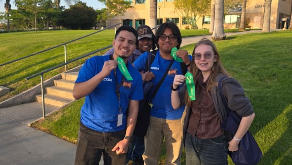 Three of MVC's HackMESA winners hold up their award ribbons