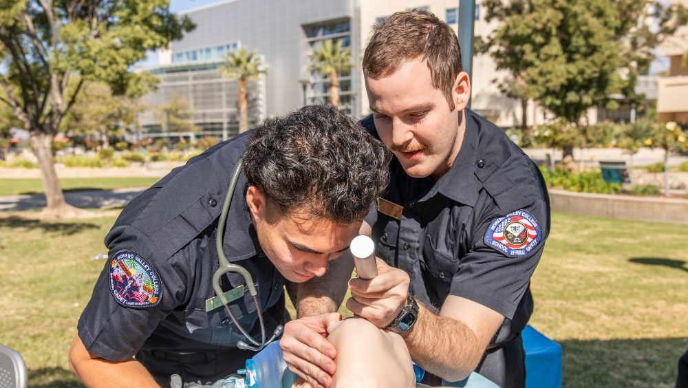 Two EMT cadets give a demonstration of CPR and checking airways
