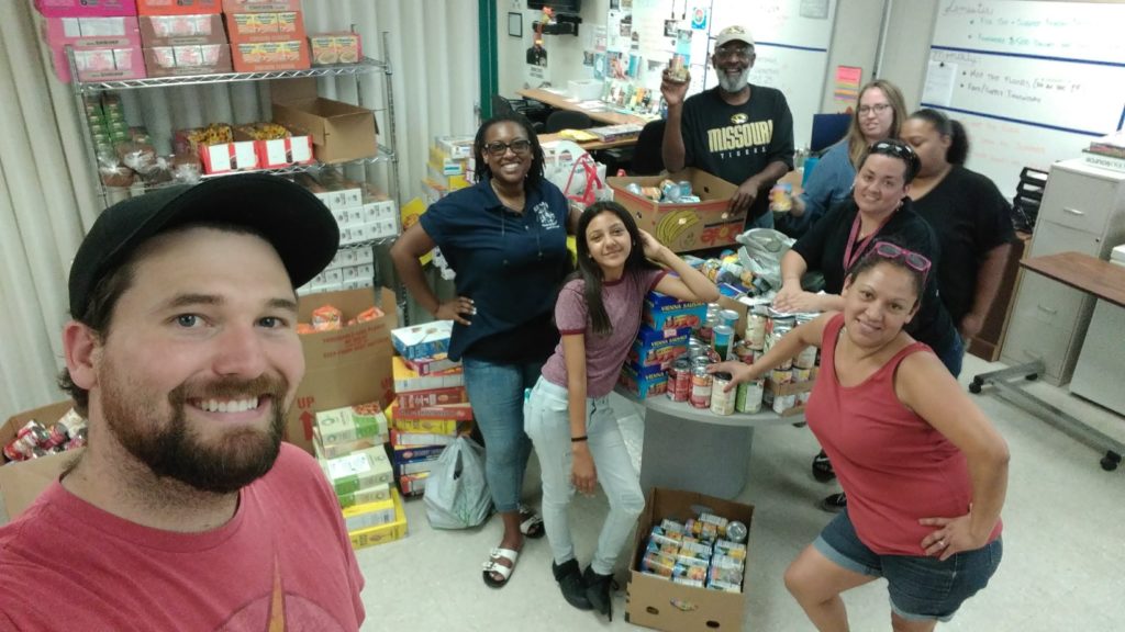 The Food Bank & Clothing Closet team pose together by donations
