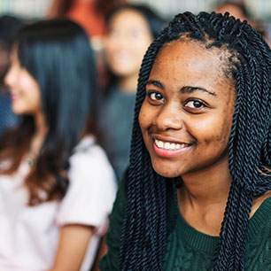 A student smiles at the camera