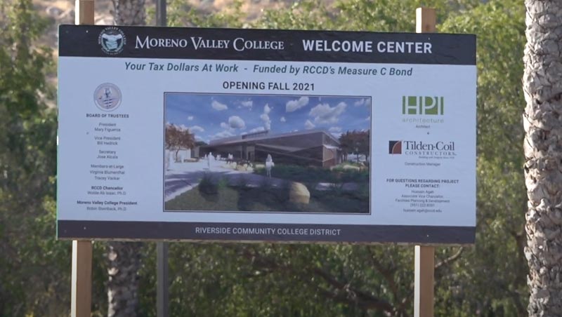 Thumbnail of virtual groundbreaking video; shows construction sign with mockup of completed building and completion date.